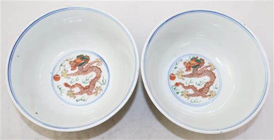 A pair of Chinese wucai dragon and phoenix bowls, Qianlong seal marks, late 19th/early 20th century, 18cm, small rim chips